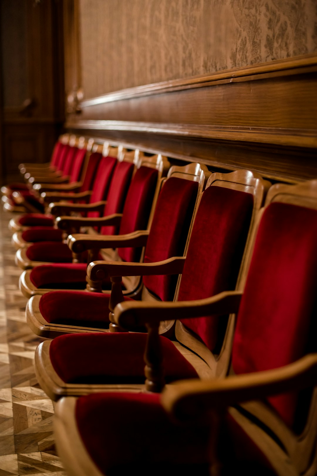 a row of red chairs sitting next to each other courtroom judge family law documents serious atmosphere
