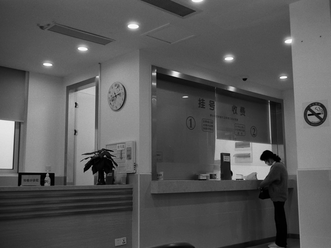 a black and white photo of a woman standing in front of a counter small business office customer service website integration