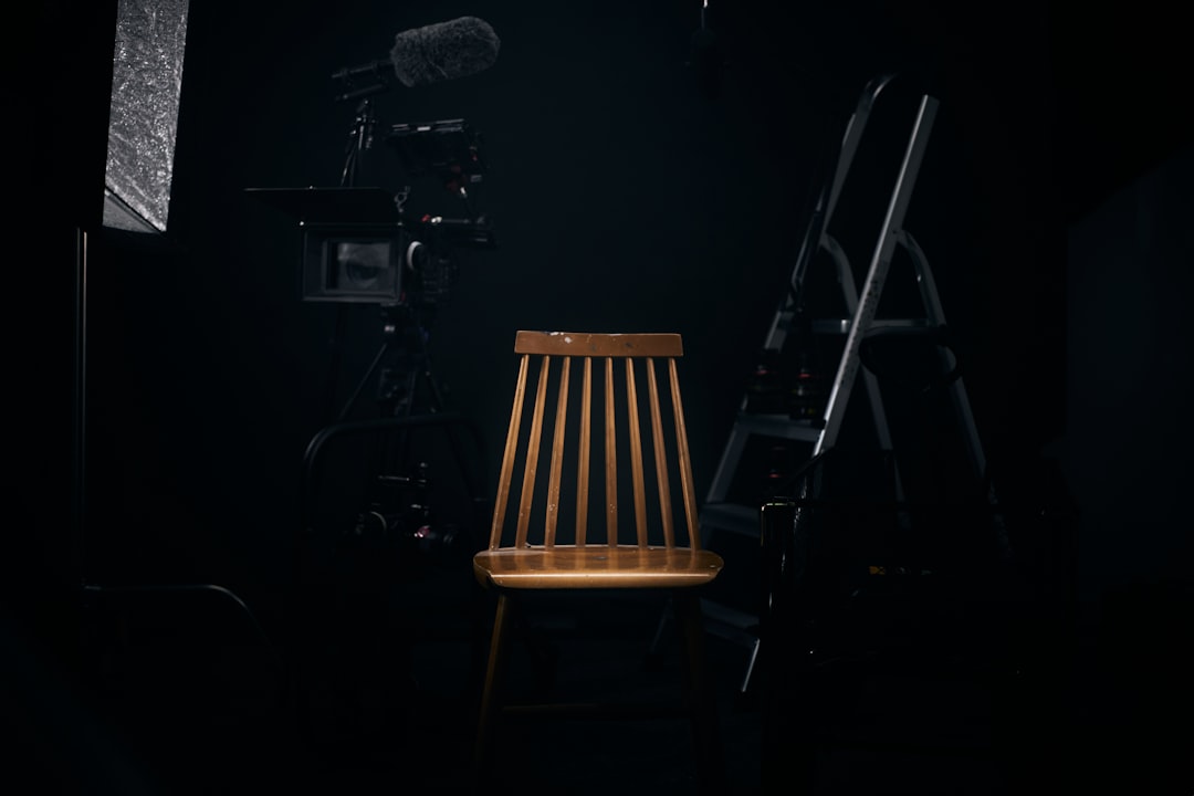 Choosing Between Photo and Ad Shoots: Objectives and Audience 1 a chair in a dark room advertisement production commercial shoot creative team