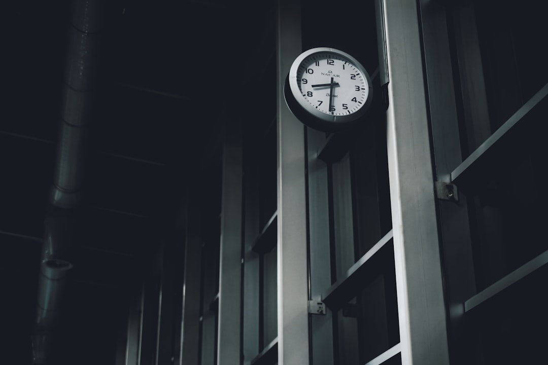 a clock hanging from the side of a building sql database timestamp automation