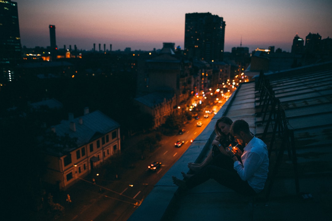Why Chasing Red Free Online Read PDF Is a Must-Read for Romance Lovers 1 a couple of people sitting on top of a roof romantic couple urban setting emotional moment
