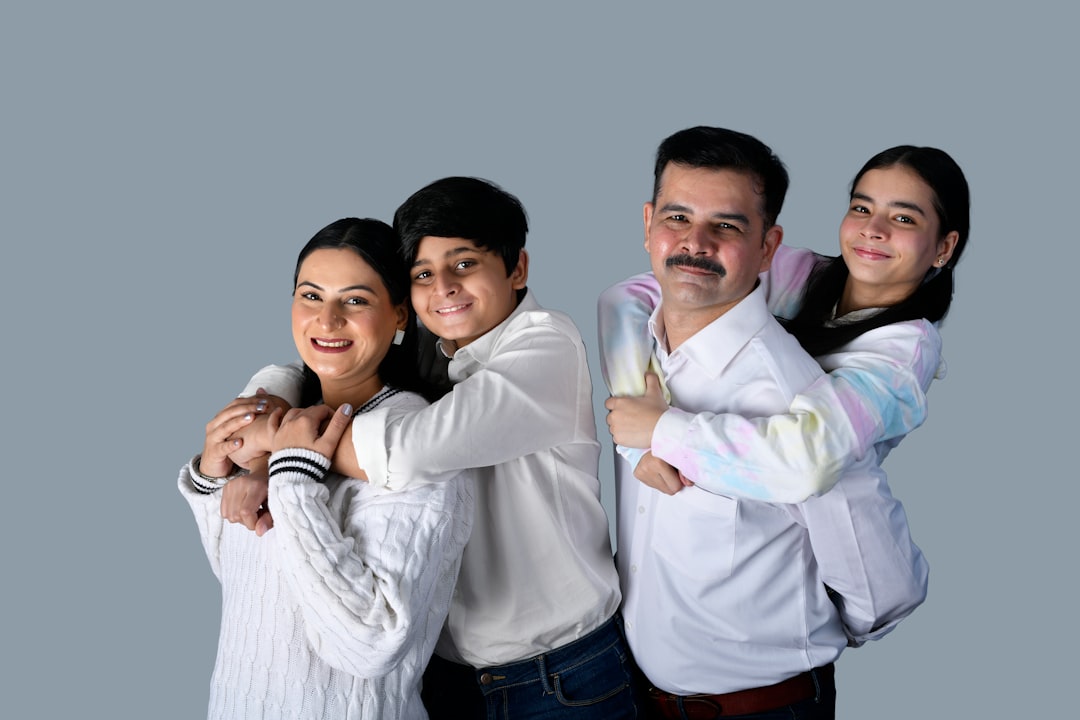 a group of people posing for a photo happy family using computer kids internet safety technology fun