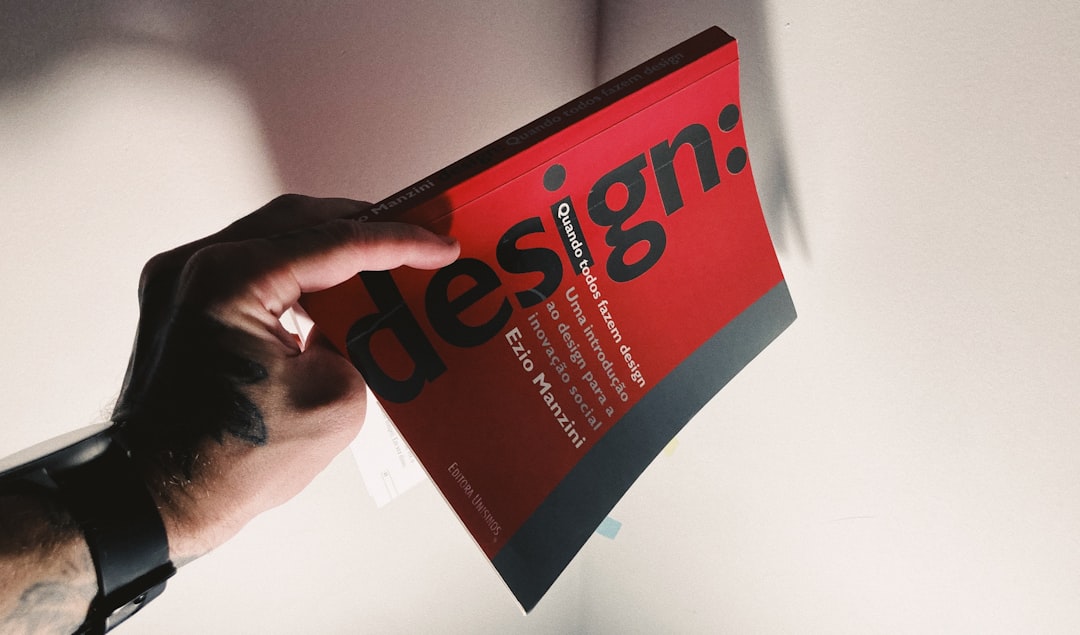 a person holding a book in their hand custom design user interface conversion optimization