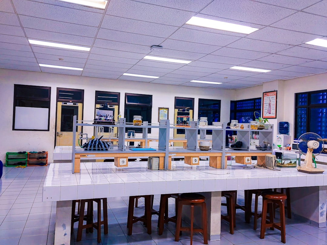 a room filled with lots of tables and stools science lab electronics unit symbols