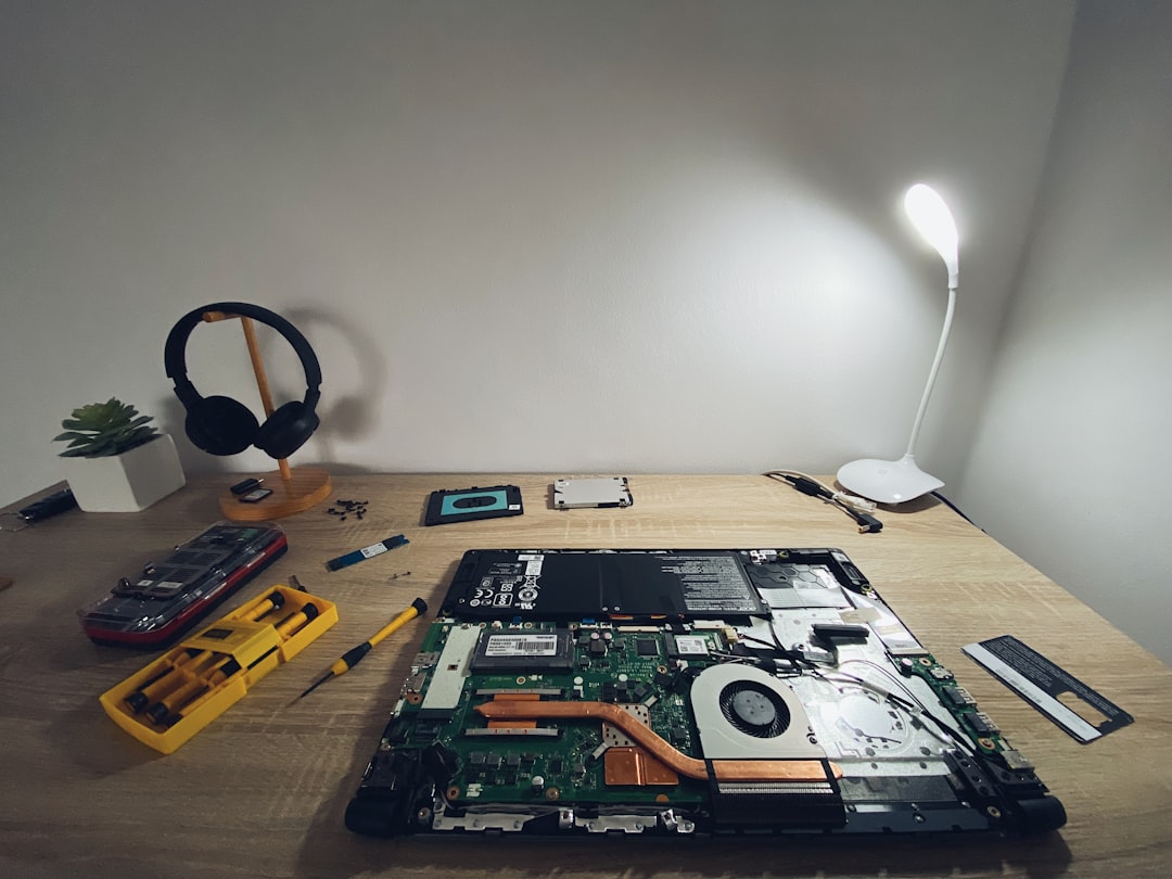 a table with a laptop and headphones on it dusty computer pc inside cleaning pc