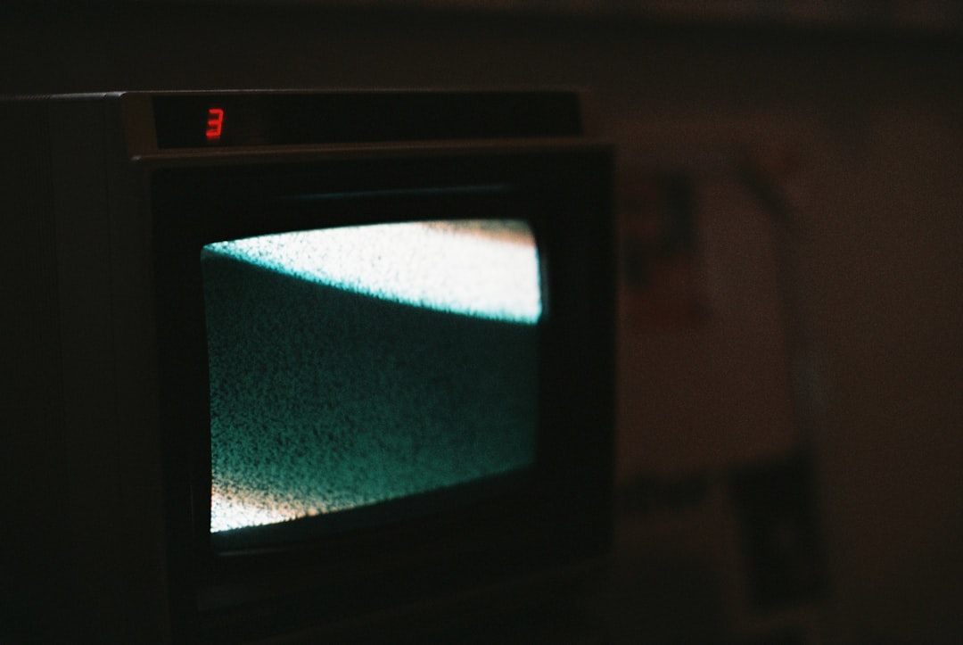 How to Get a Cheap Netflix Subscription in 2025 1 black crt tv turned on showing blue screen vpn globe digital streaming