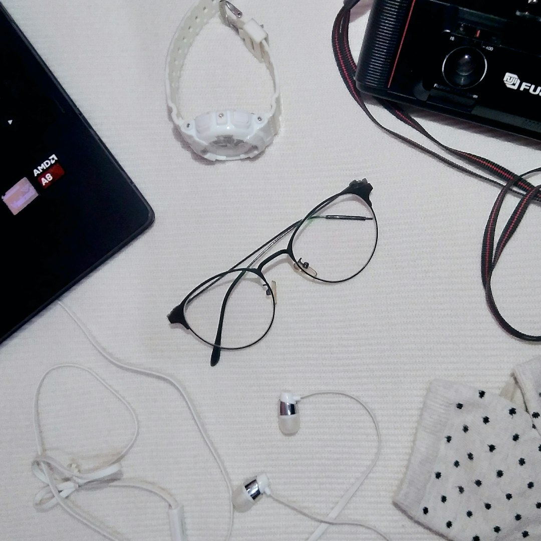 black framed eyeglasses on white table headphones laptop audio jack hardware troubleshoot