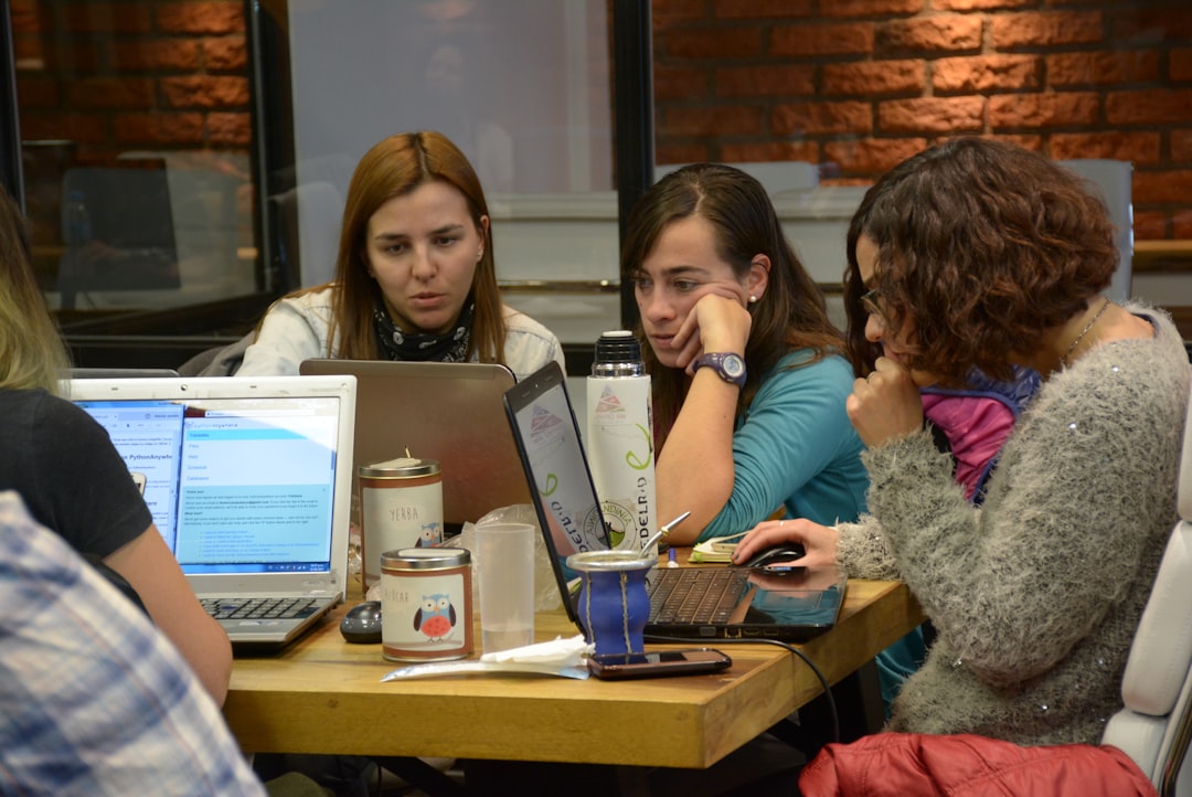 10 Invoicing Software Every USA Business Should Know About 1 group of women sitting and using laptops small business team performance evaluation digital workflow