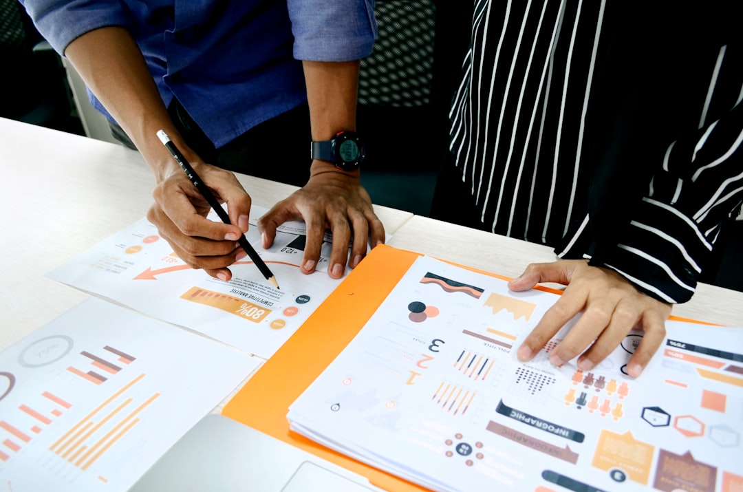 person in blue shirt writing on white paper business presentation corporate team infographics