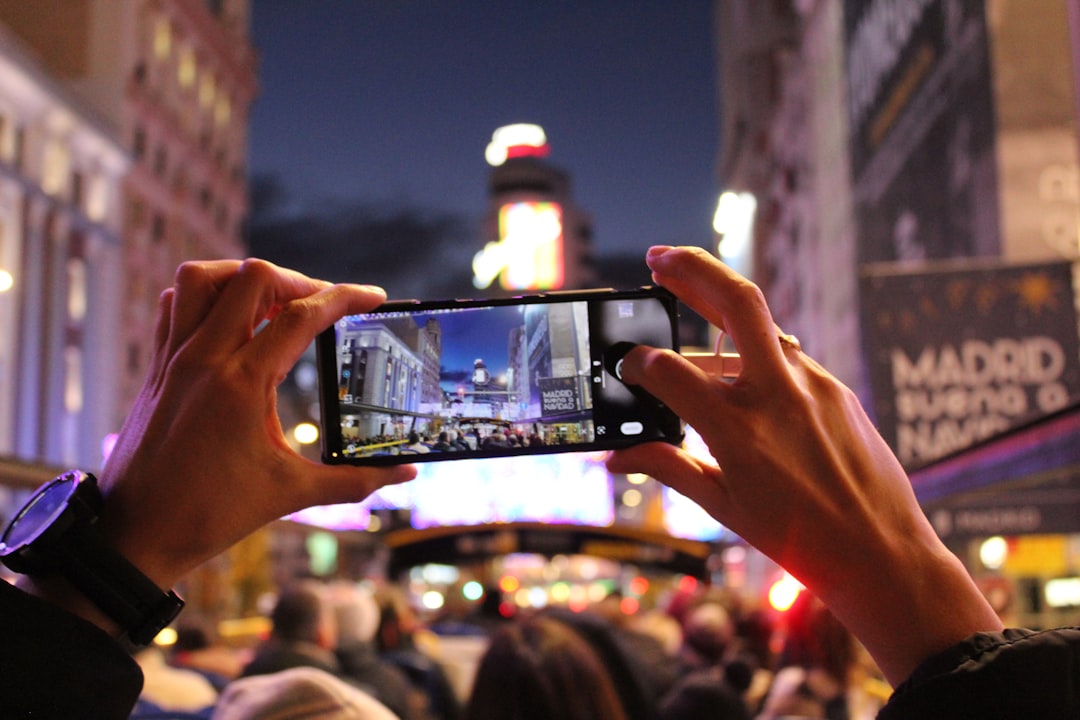 person taking photo social media video mobile ad eye catching