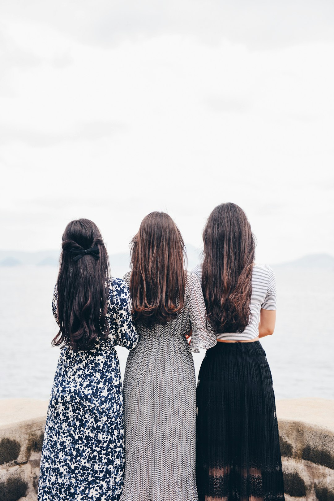 How To Repost an Instagram Story That You Really Love 2 three woman looking back and facing body of water friends sharing story instagram etiquette smartphone display