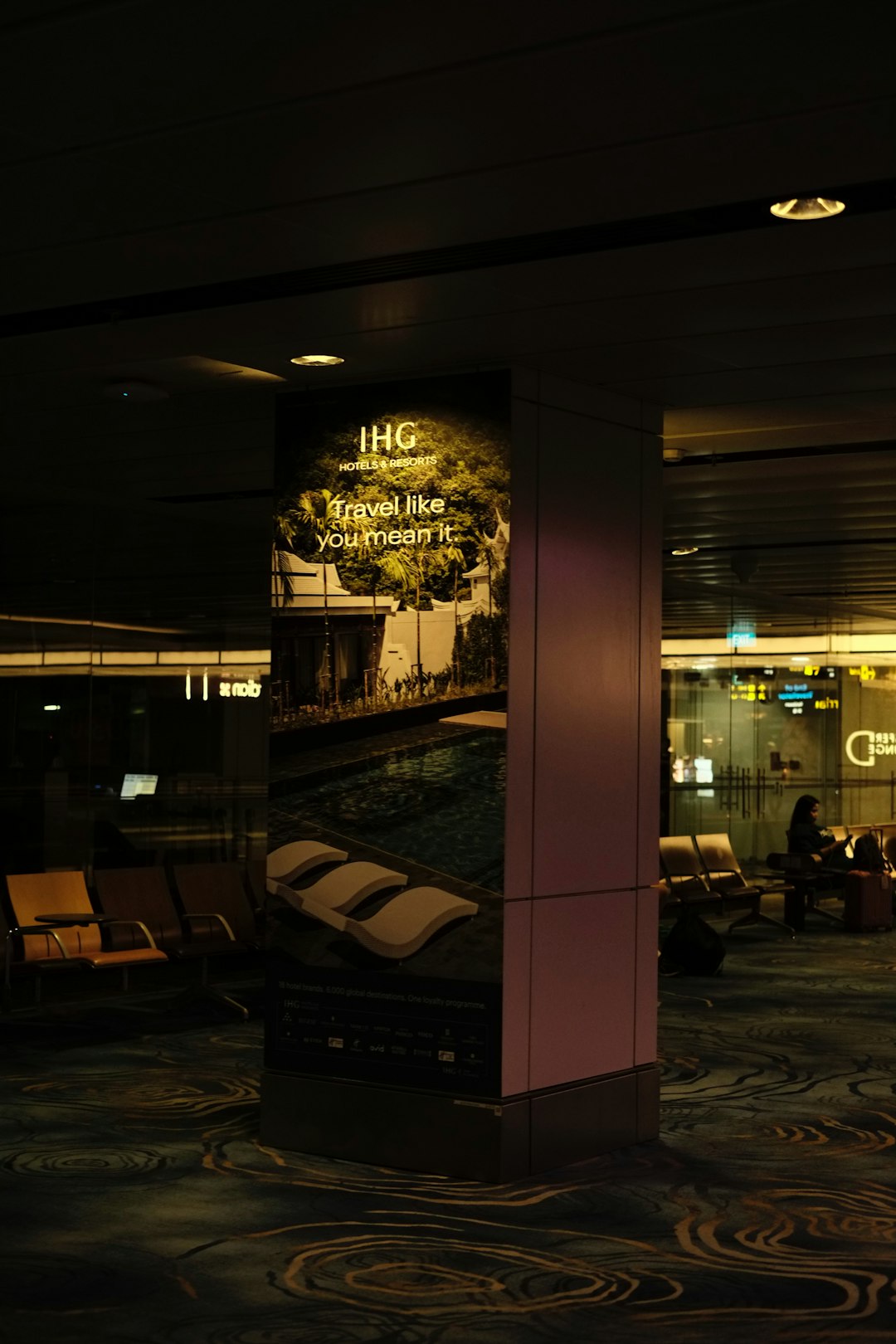 a lobby area with a large poster on the wall airport lounge business travel luxury travel