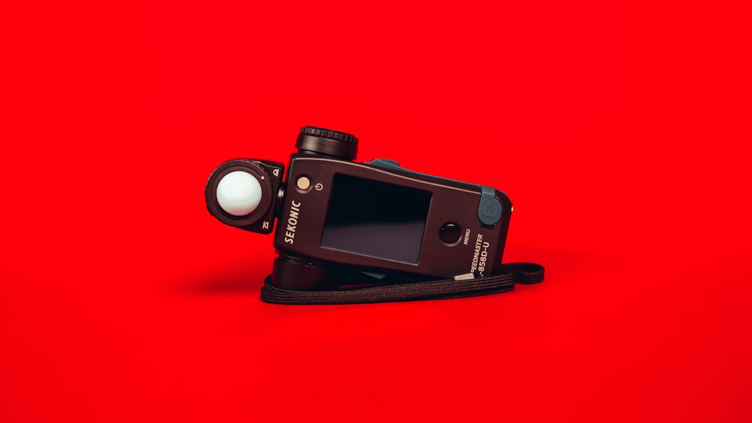 black nikon dslr camera on red surface ai video generator blog to video lumen5 tool