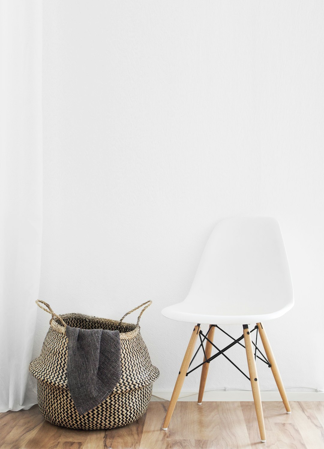 white and brown chairs beside wicker basket near white wall home money renovation finance