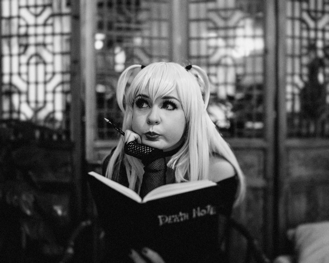 a woman with long blonde hair is reading a book manga japan reading