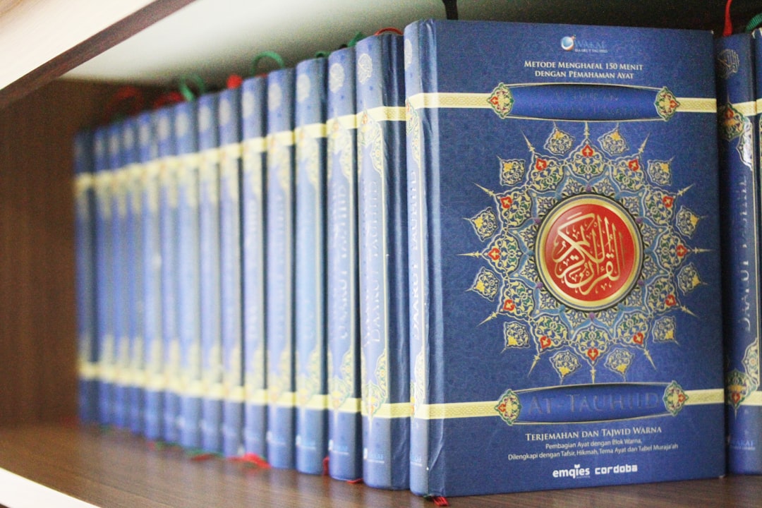 a row of blue books on a shelf scholarly conference history books islamic philosophy