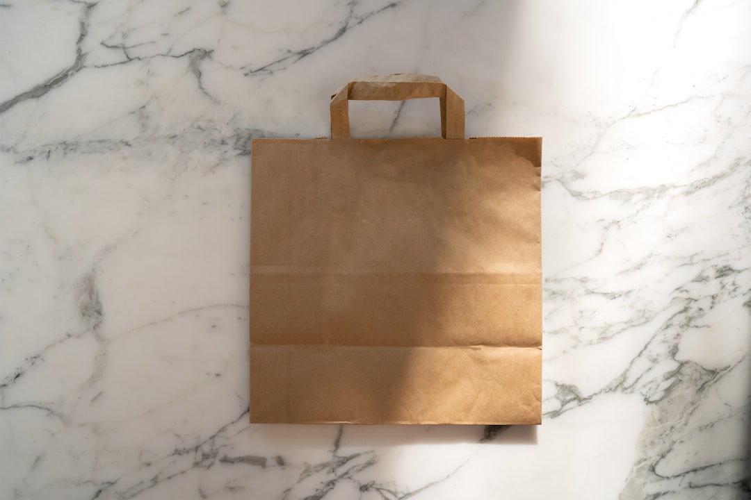 a brown paper bag sitting on top of a marble counter shopping bags checkout process retail store