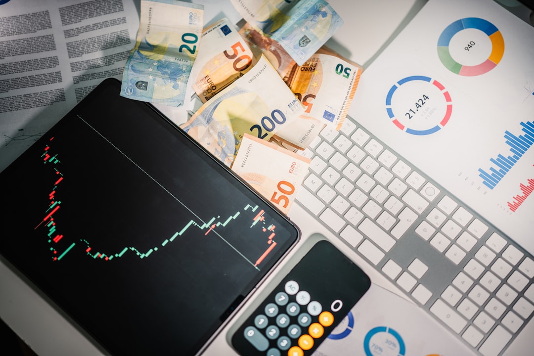 Top Benefits of Getting a UAE Crypto License for Cryptocurrency and Blockchain Ventures 2 a calculator sitting on top of a pile of money uae fintech digital banking blockchain technology