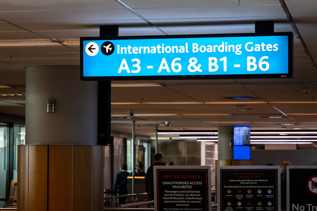 a sign in an airport that says international boarding gates boarding pass airport checkin tsa precheck indicator