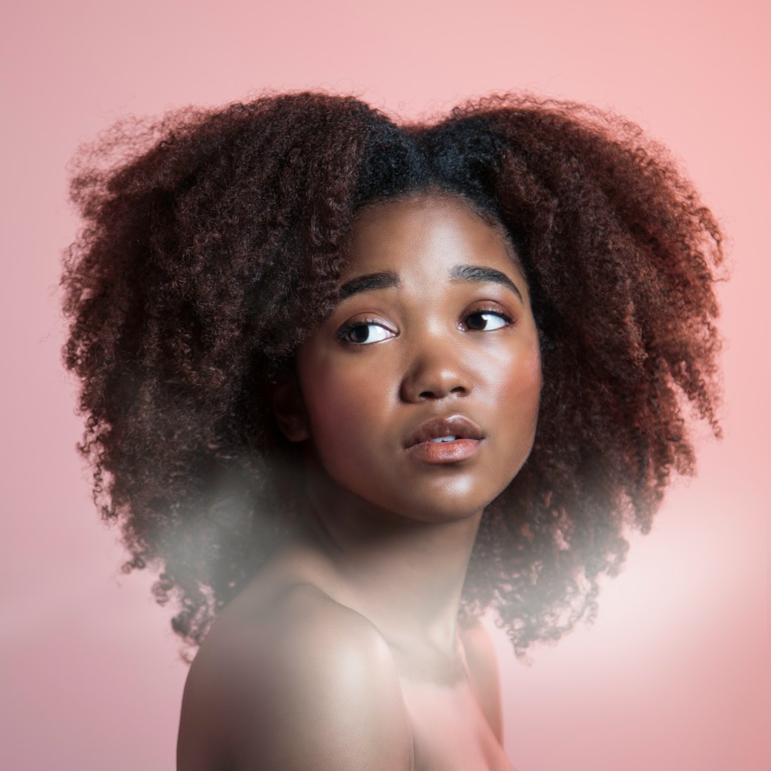 a woman with an afro is looking at the camera people talking asking questions