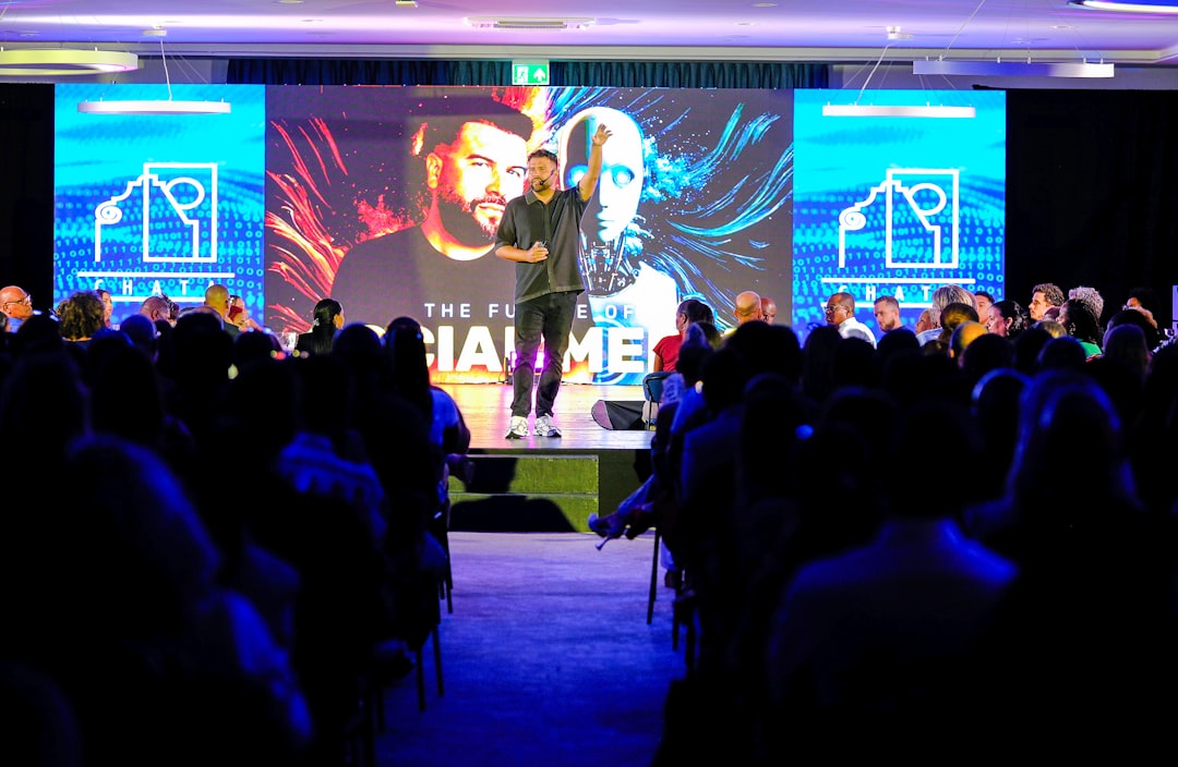 speaker presenting on stage to an audience public speaking leadership innovation