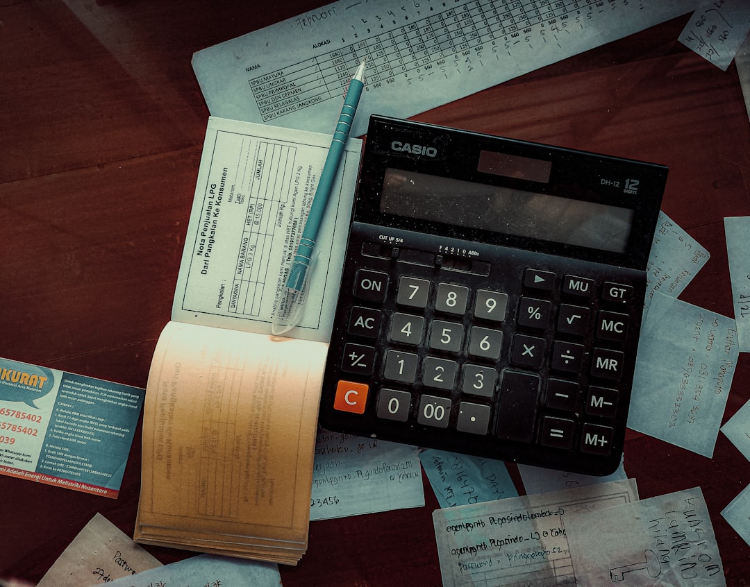 Best 6 Thryv Software Alternatives in 2025 2 a calculator sitting on top of a wooden table accounting software freelancer working invoicing