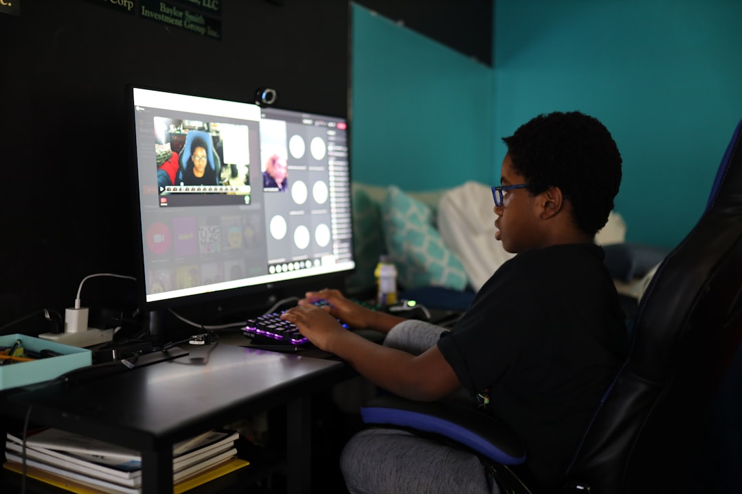 man in black shirt using computer video editing production studio creative team
