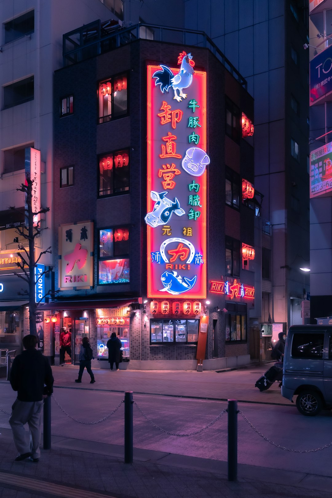 a city street at night with people walking on the sidewalk anime production creator revenue animation studio