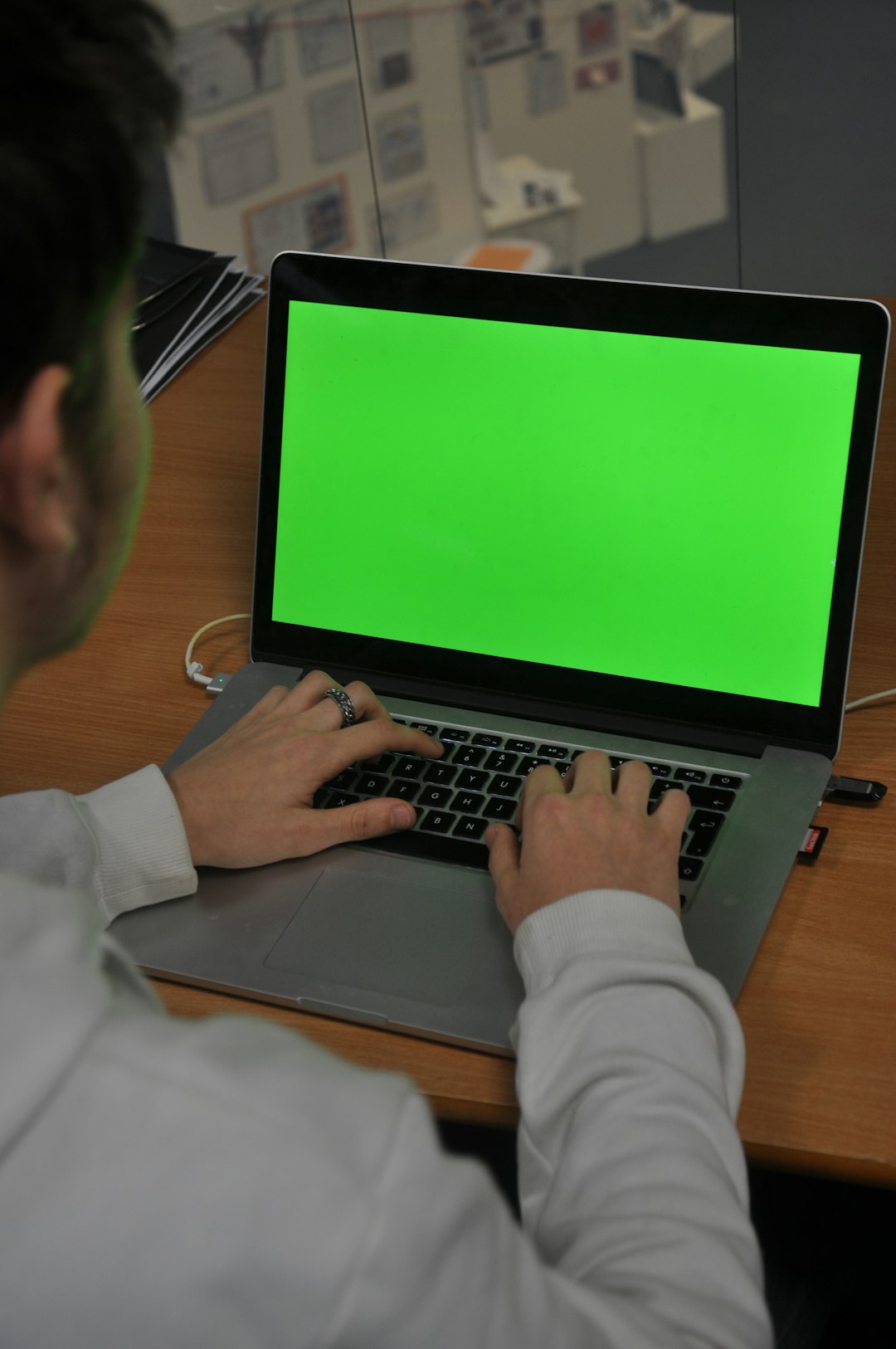 a man using a laptop add person to video green screen effect editing tools