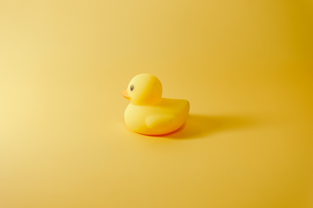 a yellow rubber duck sitting on a yellow surface duckduckgo news search engine