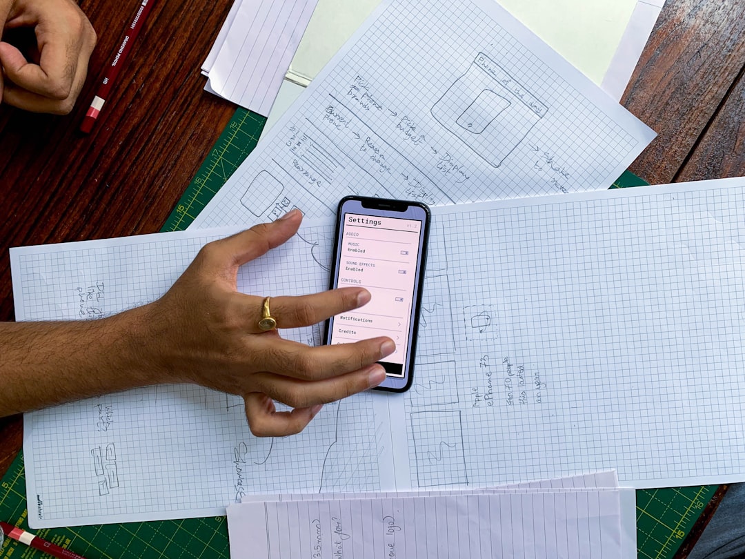a person holding a cell phone on top of a table project planning trello app kanban board productivity apps