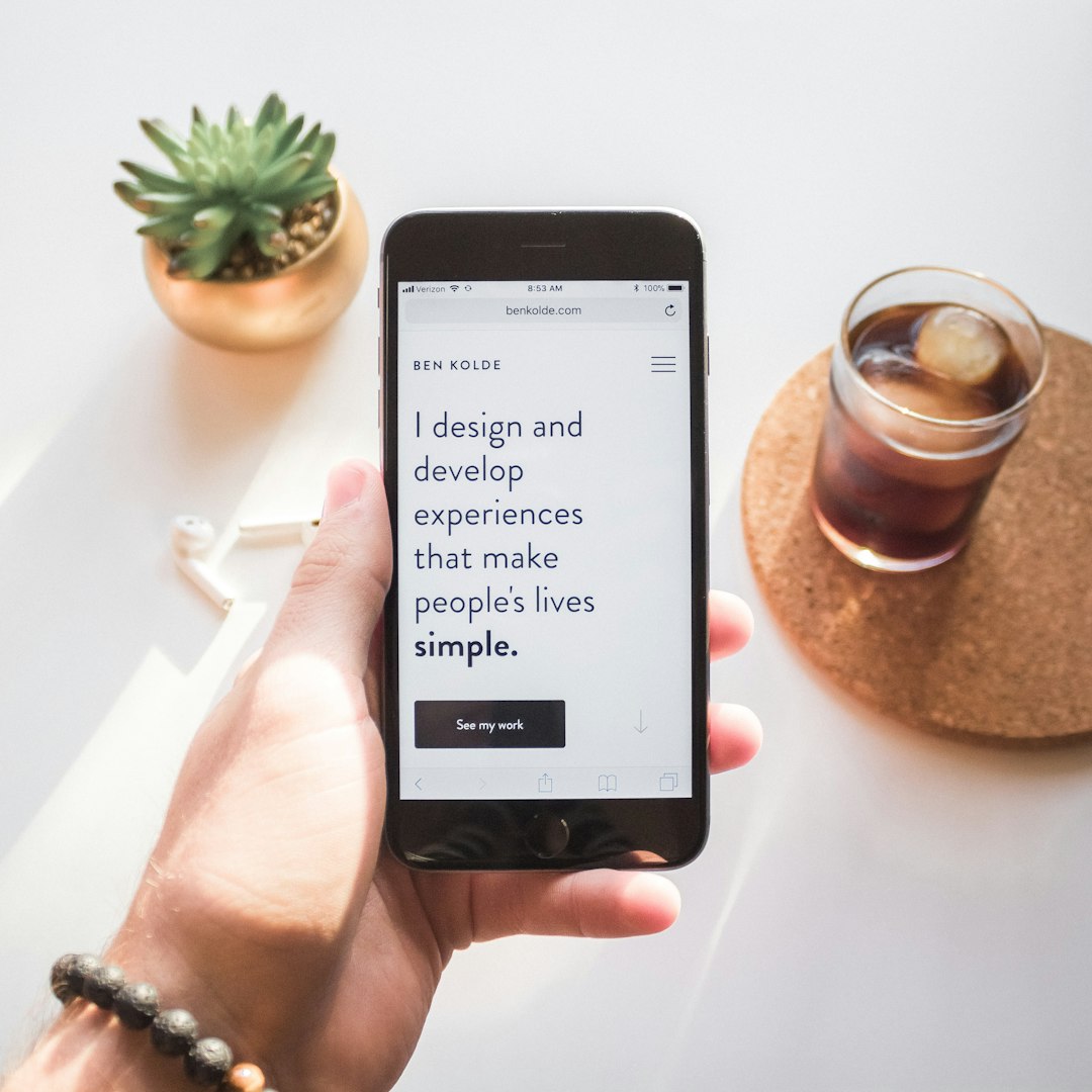 How do I add files to Stick Nodes? 2 person holding space gray iphone 6 displaying i design and develop experiences that make peoples lives simple text zip file icon download arrow phone screen 1