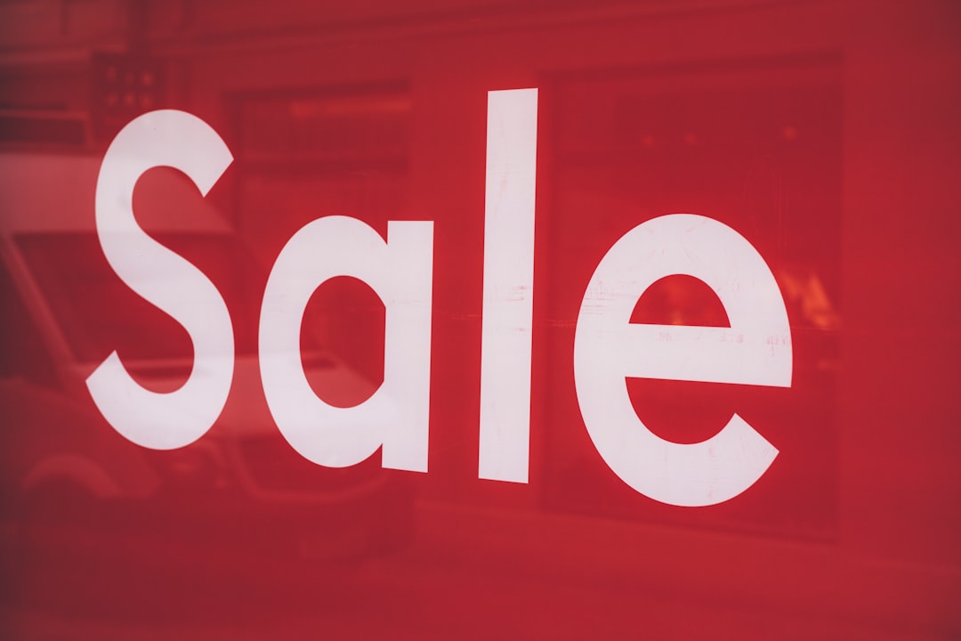 a close up of a red sale sign with a van in the background shopify dashboard store analytics online sales