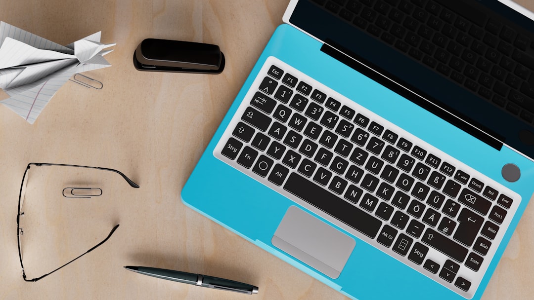 a laptop computer sitting on top of a wooden desk cybersecurity corporate training compliance software