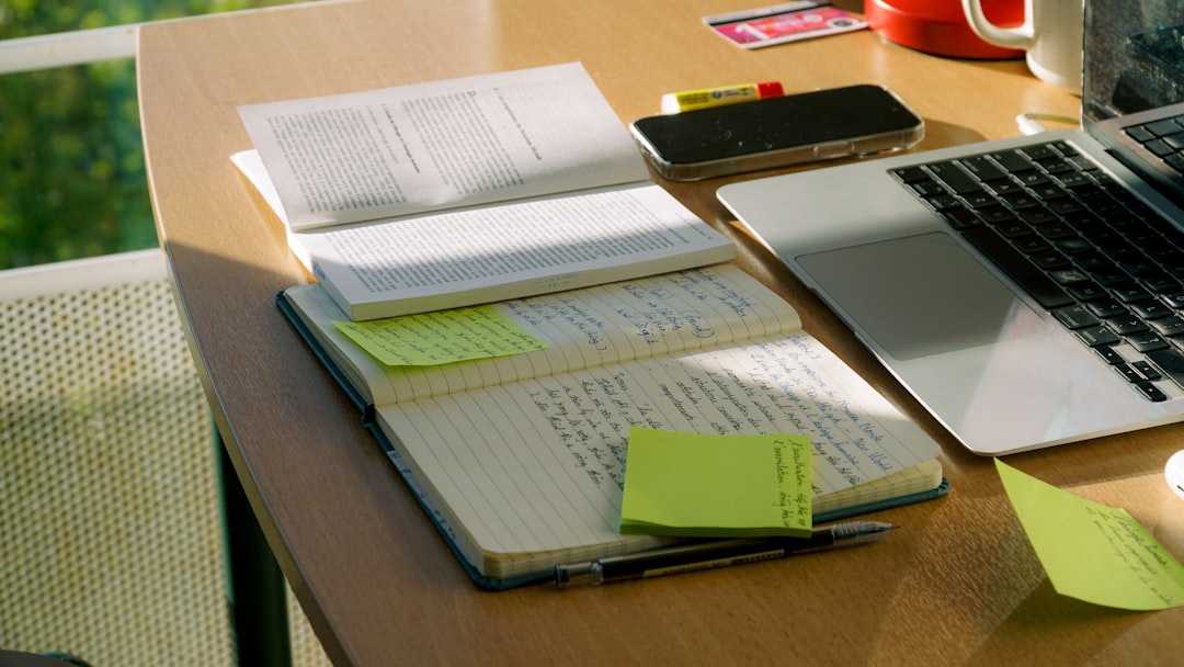 How does Notes AI handle archiving old notes? 1 notebook and laptop sit on a work desk note list digital notes organized files