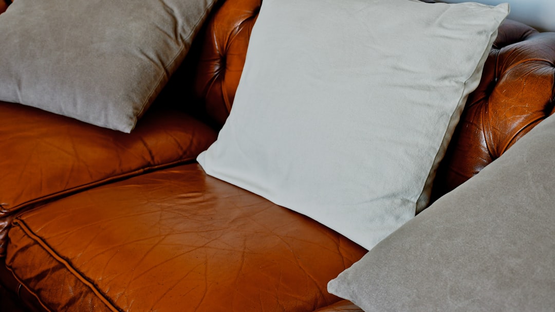 white pillow on brown leather couch triangle cushion thai pillow relaxing pillow home comfort