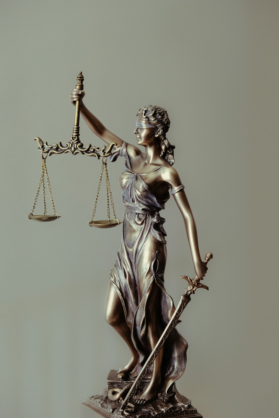 Can I use stock photos in advertising campaigns? 2 woman in gold dress holding sword figurine lawsuit online license copyright notice