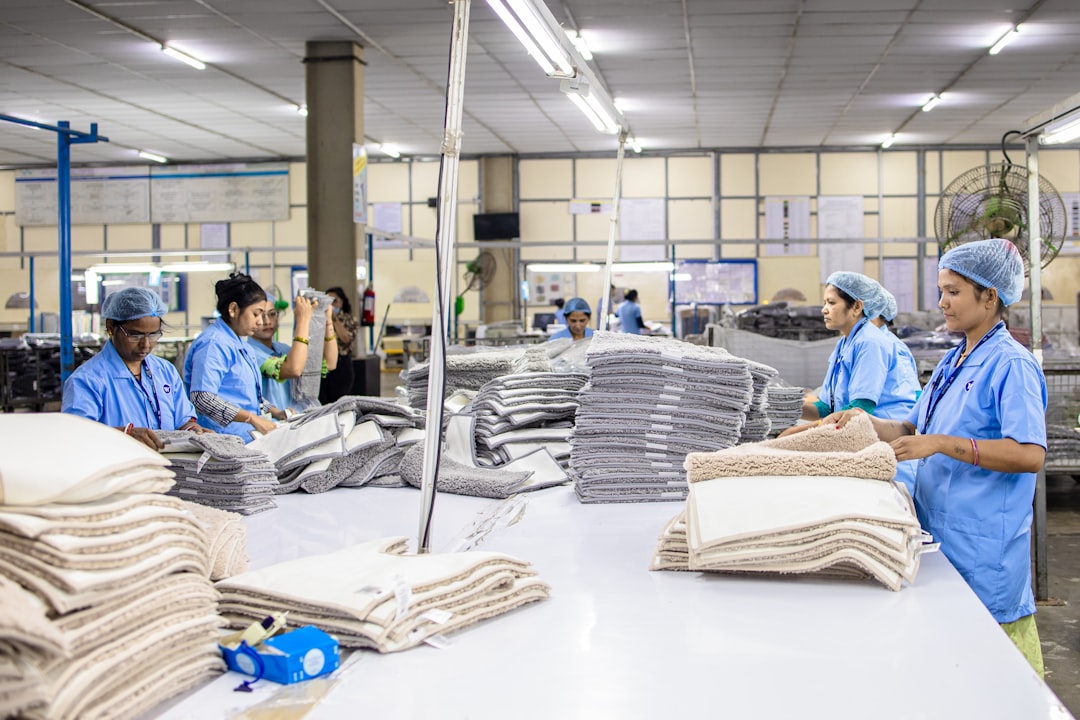workers are assembling textiles at a factory factory workers tote bag production quality control