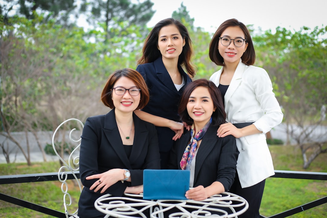 What role does AI play in identifying and targeting long-tail keywords for law firms? 2 a group of women posing for a photo law firm team happy clients legal consultation 1