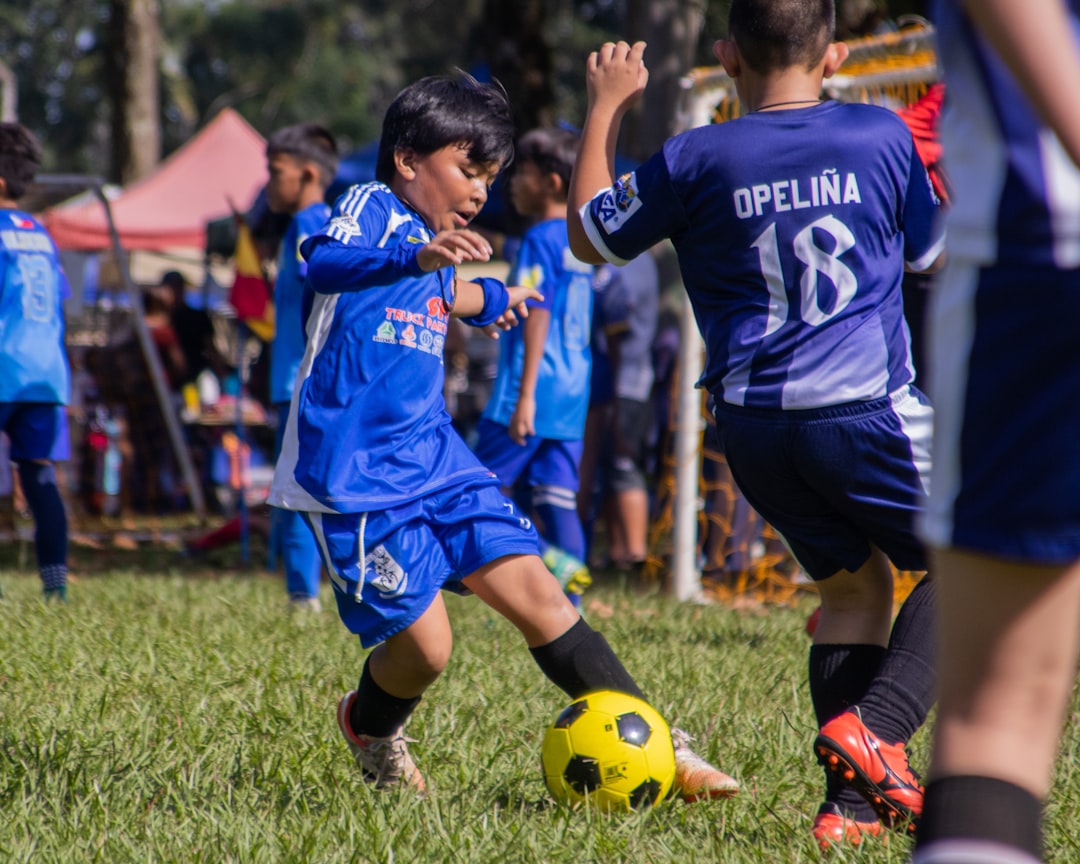 a group of young boys playing a game of soccer youth sports league soccer tournament digital management