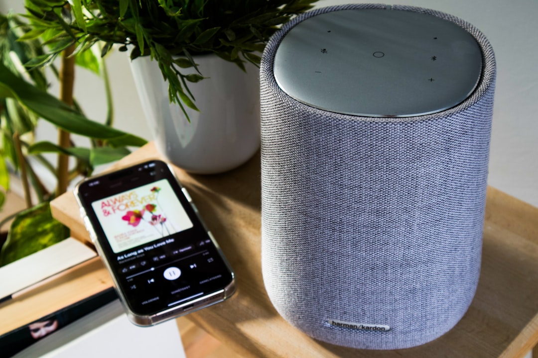 AI Assistants: Complete Comparison Guide 2025 1 a smartphone is connected to a cylinder speaker smart home devices virtual assistant