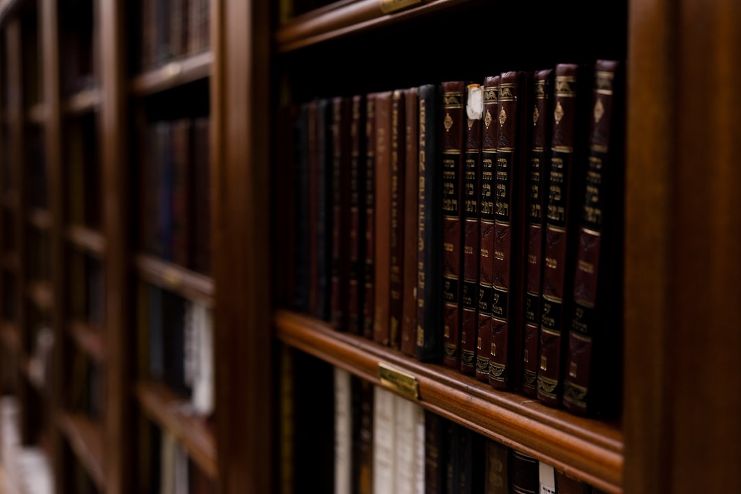 Academic Review: Siham Ouardi’s Google Scholar Contributions 1 close up photo of books in brown wooden shelf law firm team happy clients legal consultation