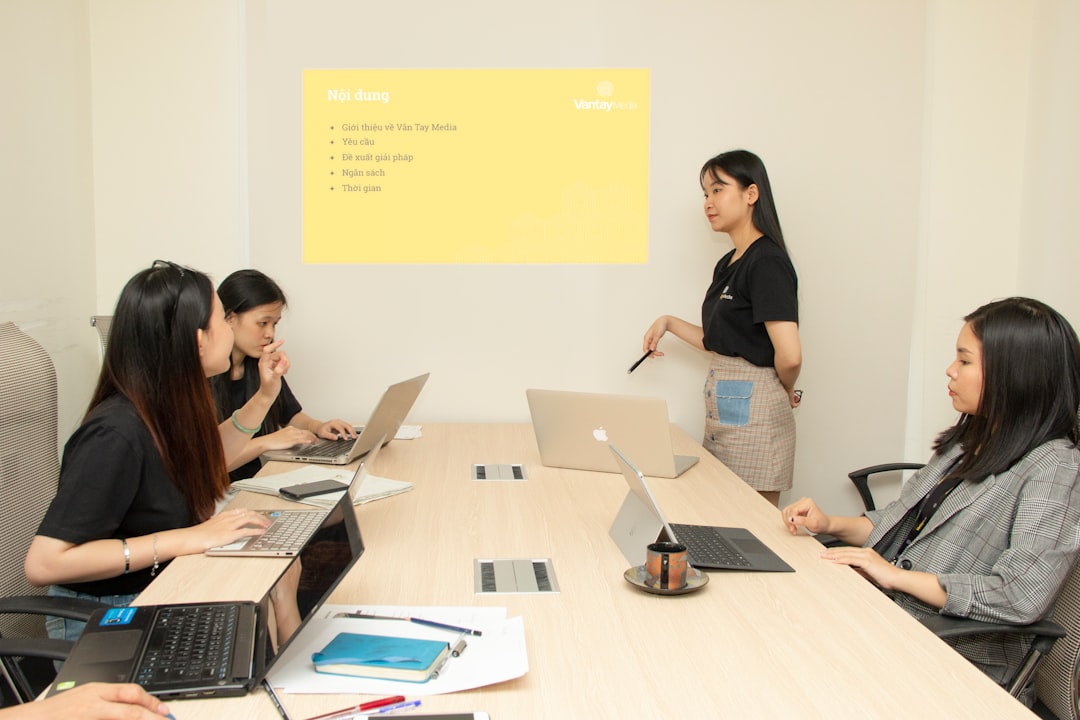 four women inside room small business team performance evaluation digital workflow