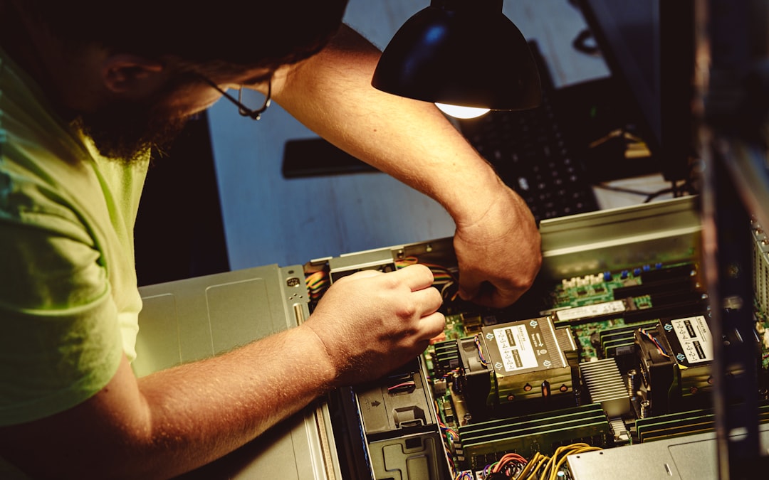 man repairing a computer server under a lamp power supply pc components computer repair