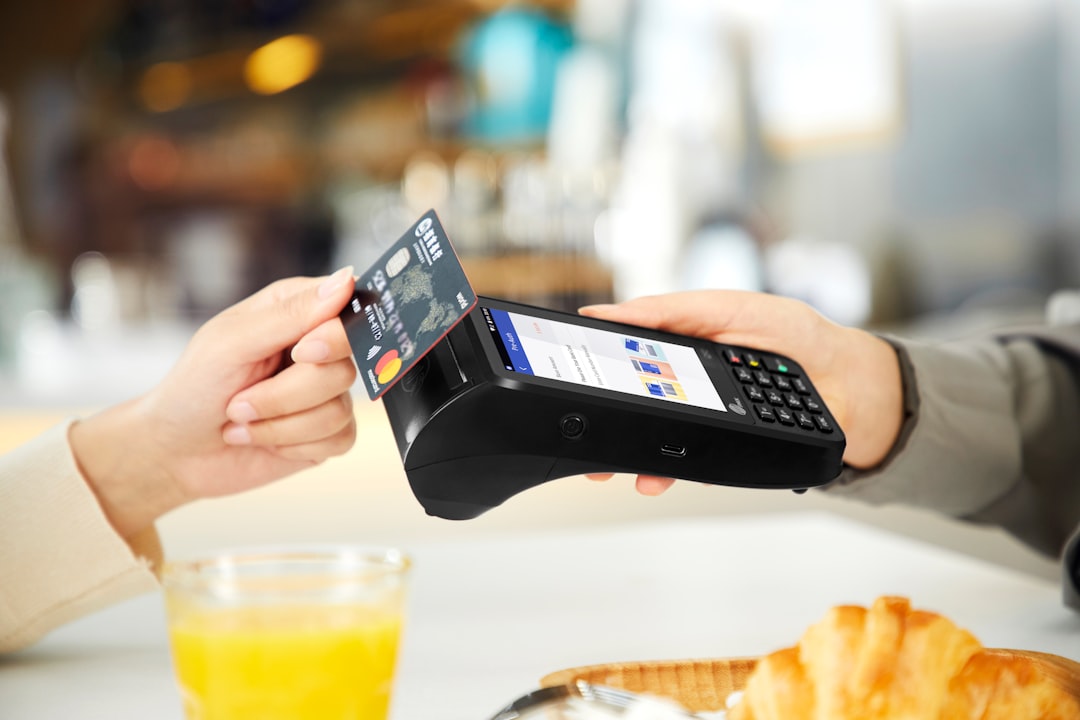 person holding black smartphone near clear drinking glass mobile paymentssquare invoicesmodern billing