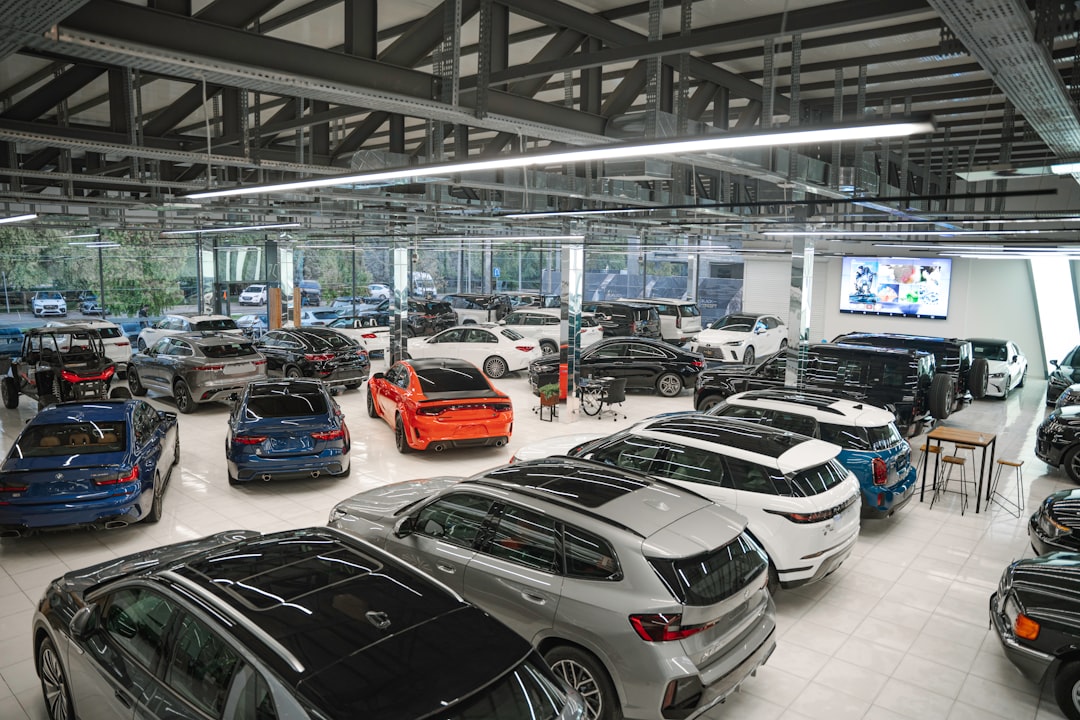 a bunch of cars are parked in a garage car dealership crm software automotive technology