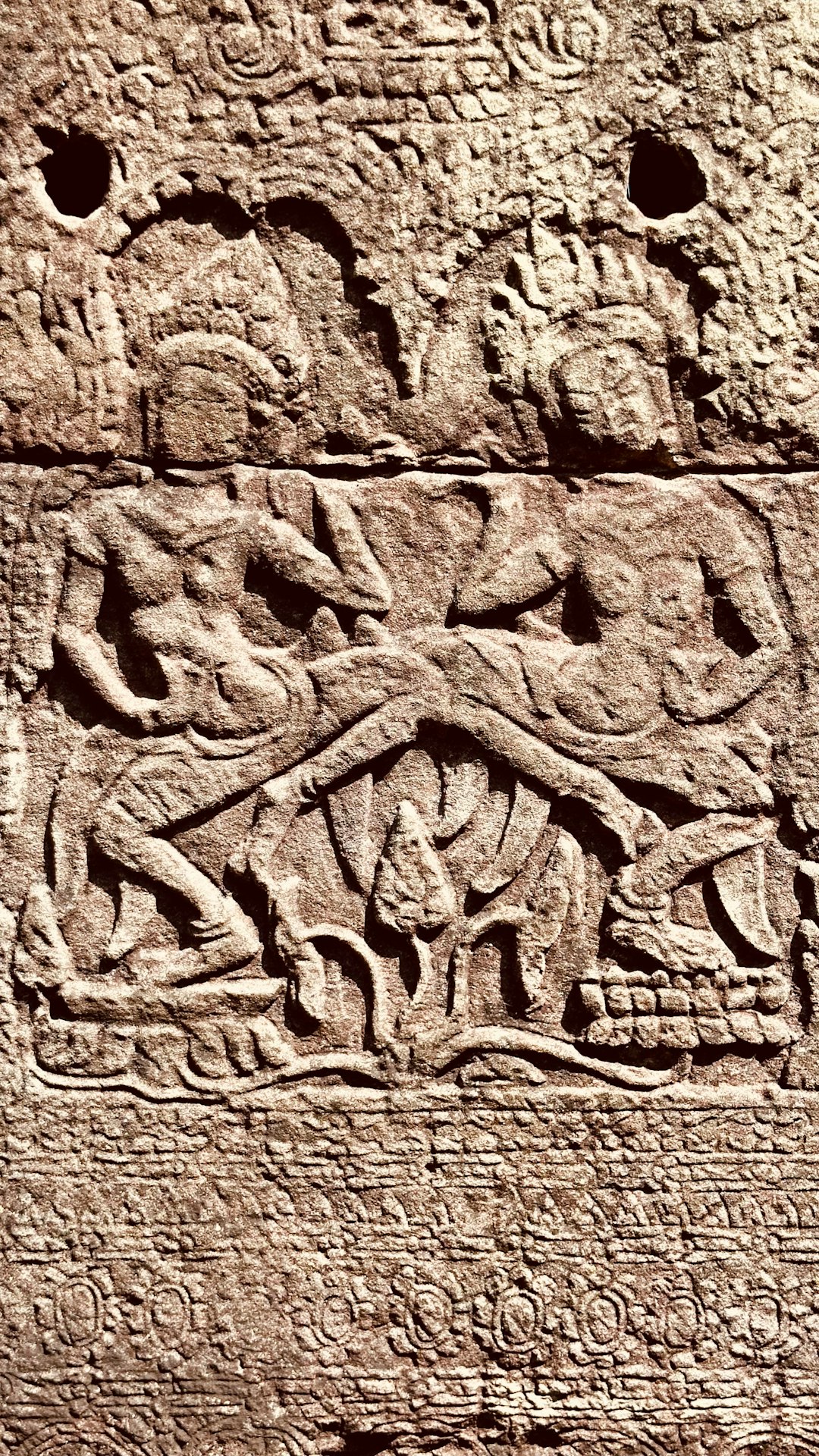 a carving on the side of a building cult of the lamb gameplay temple ritual