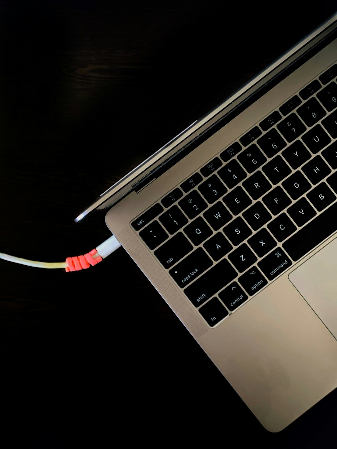 a close up of a laptop on a table iphone connected laptop charging cable