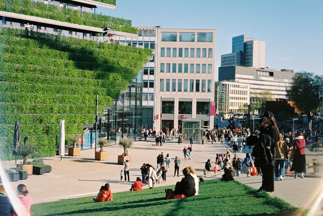 a group of people outside a building green spaces public parks eco friendly city