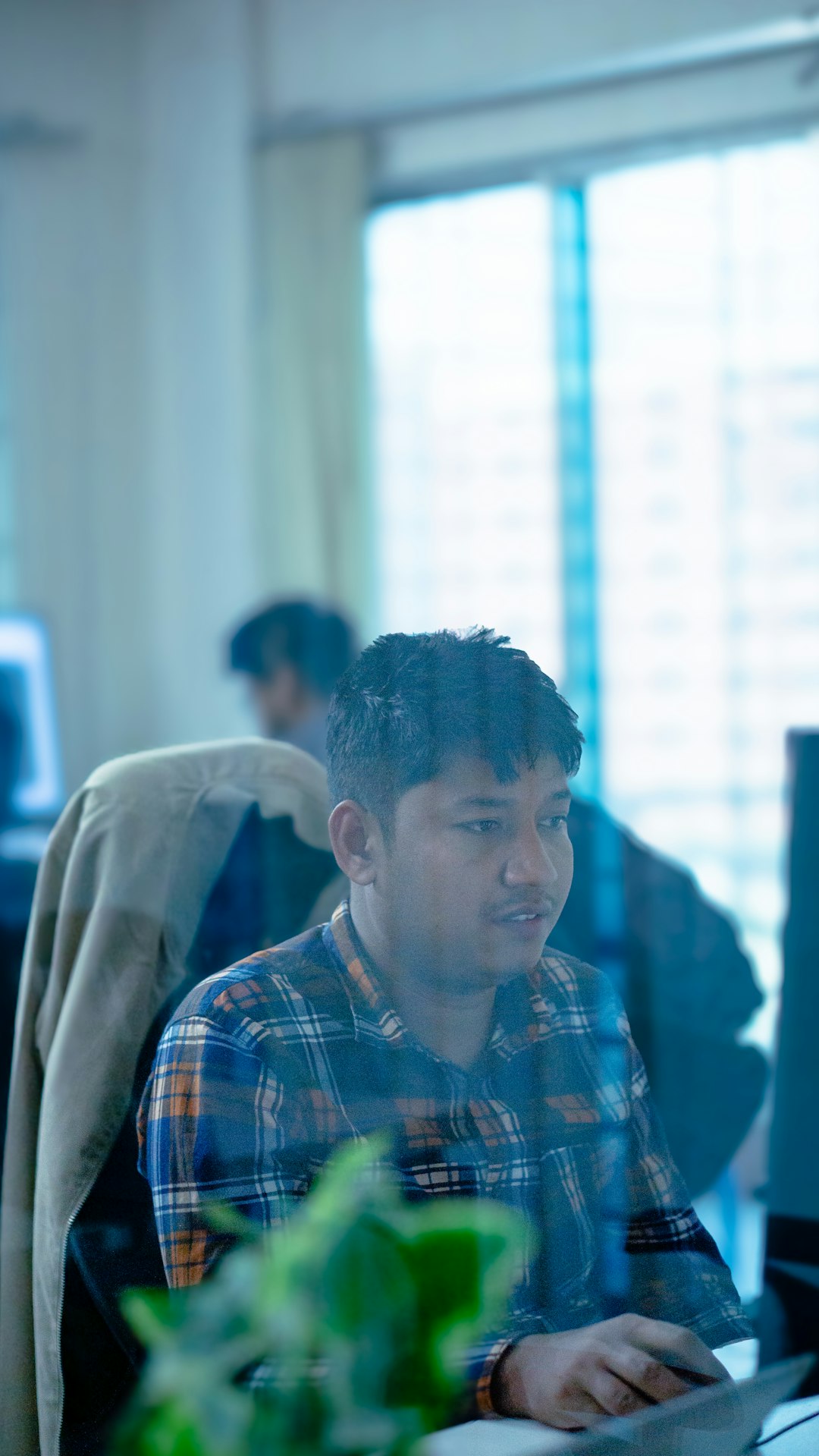 a man sitting at a desk in front of a computer task manager end task background process
